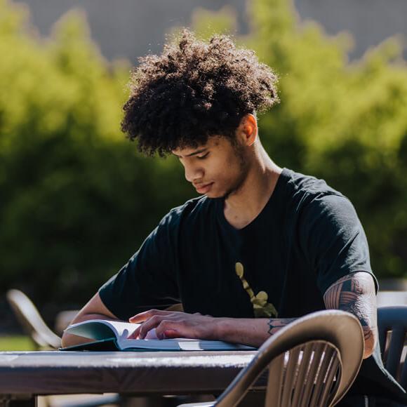Male student studying on campus