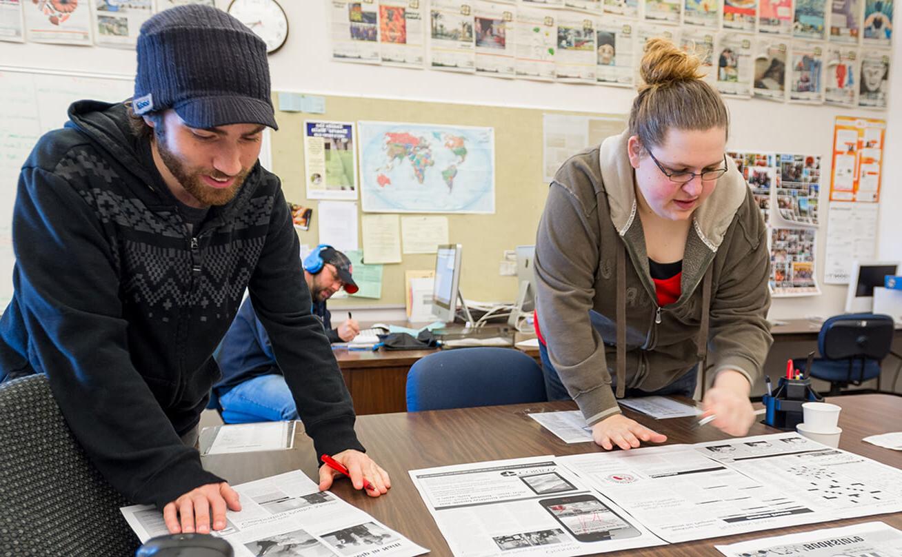 photo of students working on a newspaper layout